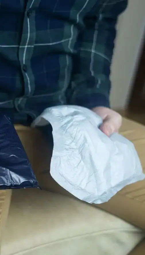 Image of man holding incontinence pads as part of overactive bladder treatment Sheffield 